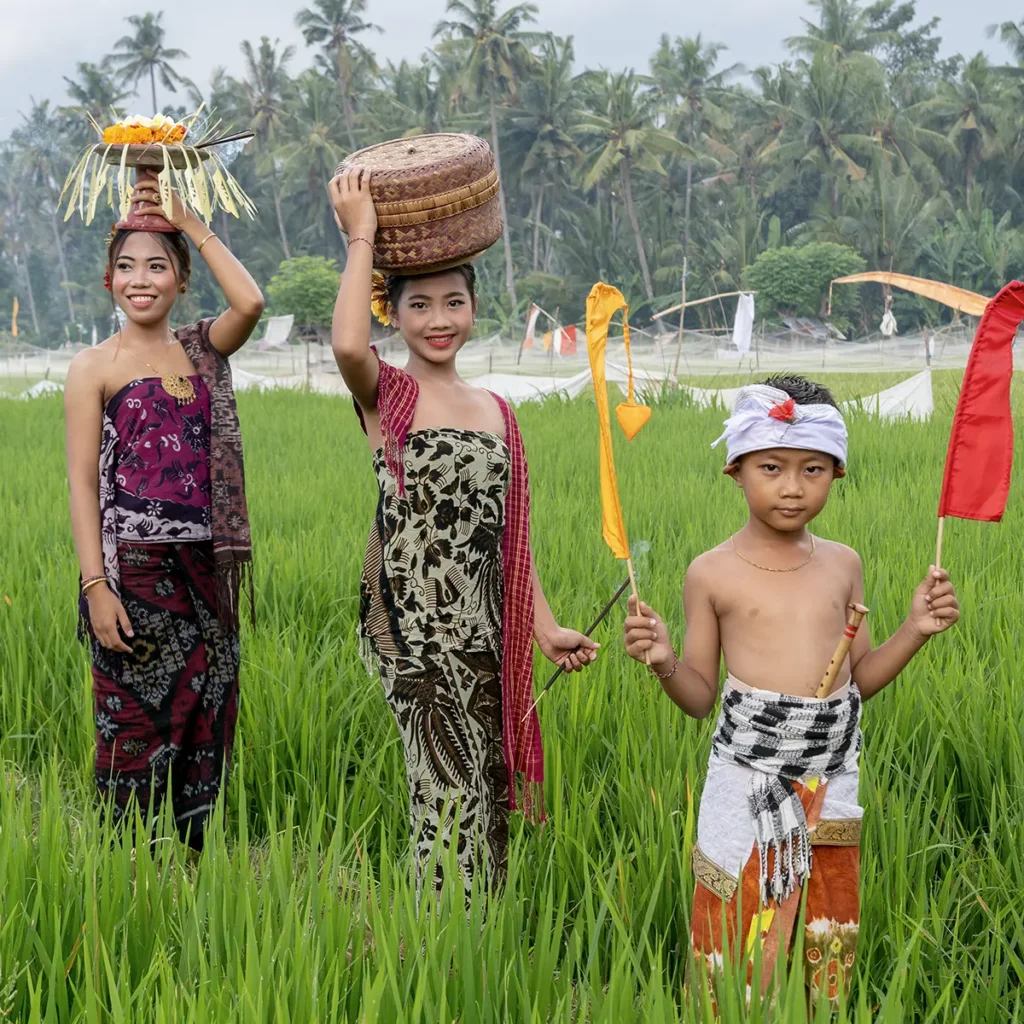 Lokale bevolking in traditionele kleding tussen groene rijstvelden op Bali, Indonesië