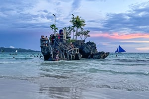 Iconische Willy’s Rock met kapelletje voor de kust van White Beach op Boracay, Filipijnen.