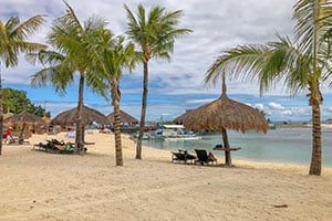 Prachtig wit zandstrand op Mactan Island met helder turquoise water, wuivende palmbomen en een tropische sfeer.