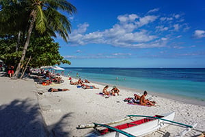 Toeristen relaxen op het strand van Alona op Bohol, Filipijnen